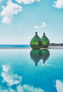 Natural materials were used in abundance and this is something I champion in my interior design projects. It seems that this is the antithesis of Mykonos style and charm - embracing and celebrating the natural beauty of the island. Clearly the views were the hero of the hotel's positioning, with its cliff-side location overlooking the sparkling waters and beyond. The dazzling bar-side infinity pool looked beyond to the sea, as did the villa's private pools on individual balconies. Our balcony had a hot-tub which was the perfect place for champagne sipping whilst we looked out across the water.
